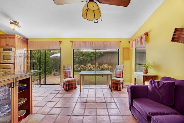 tiled living room featuring beverage cooler and lofted ceiling