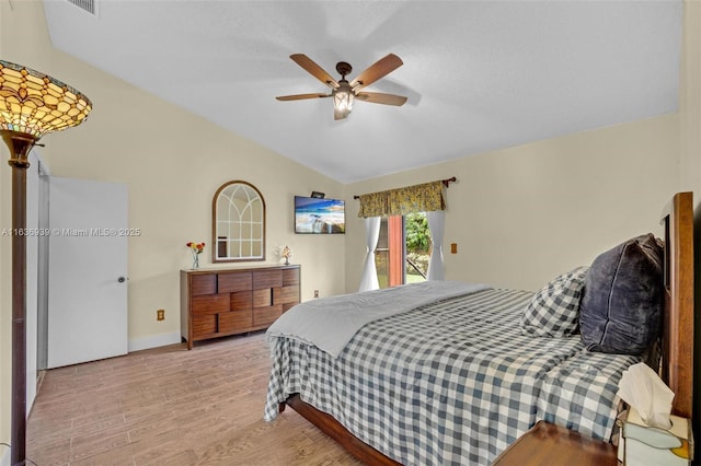 bedroom featuring light wood-type flooring, ceiling fan, and lofted ceiling