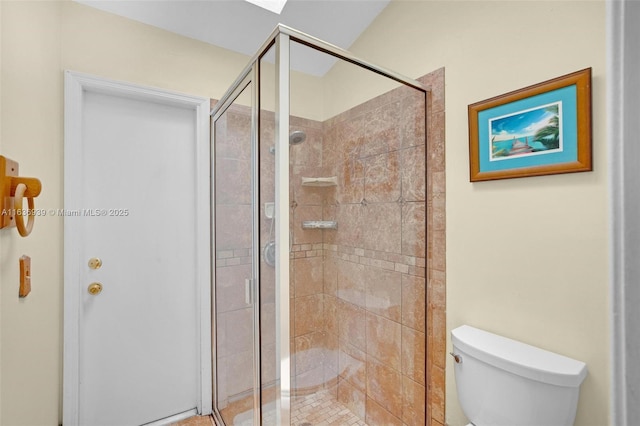 bathroom with an enclosed shower and toilet