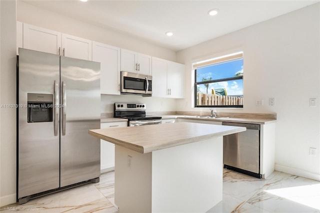 kitchen featuring light tile patterned flooring, stainless steel appliances, and a center island