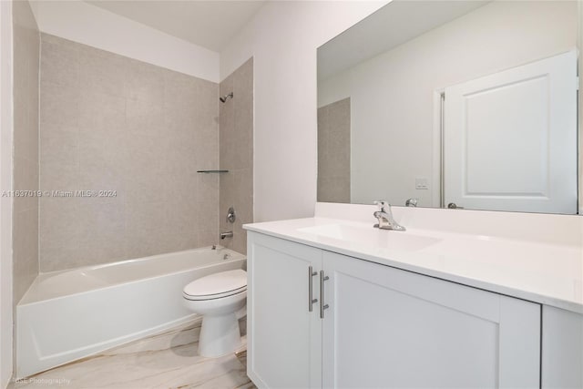 full bathroom featuring toilet, tiled shower / bath combo, vanity, and tile patterned flooring