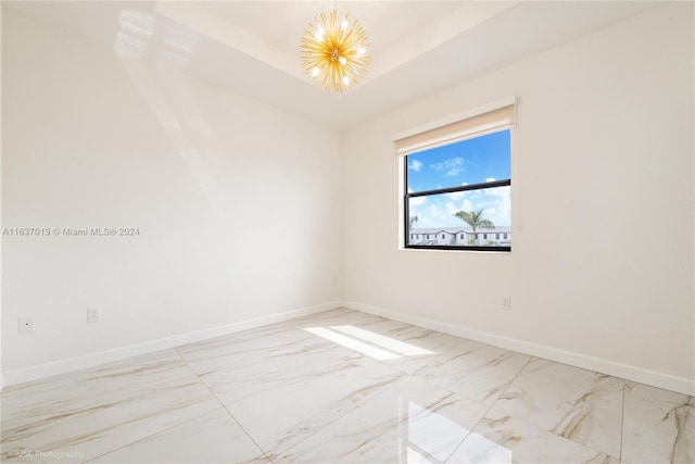 spare room featuring light tile patterned floors and an inviting chandelier