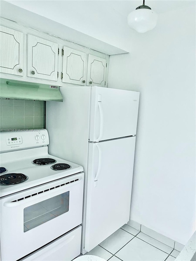 kitchen featuring white appliances, custom exhaust hood, and light tile patterned floors