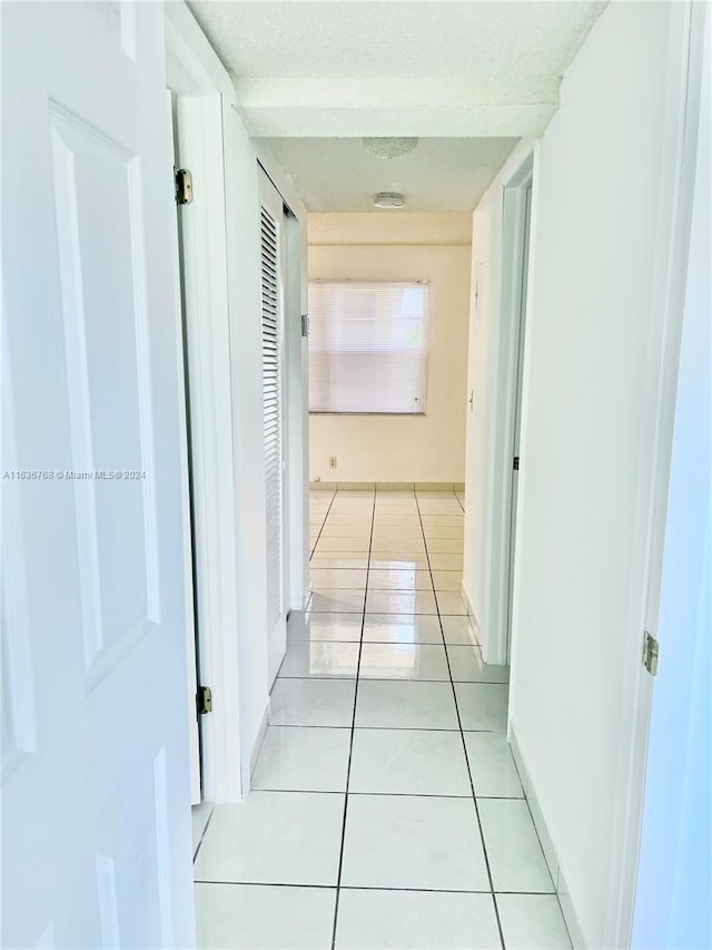 corridor with light tile patterned floors