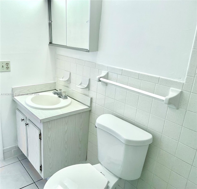 bathroom featuring backsplash, toilet, vanity, tile walls, and tile patterned floors