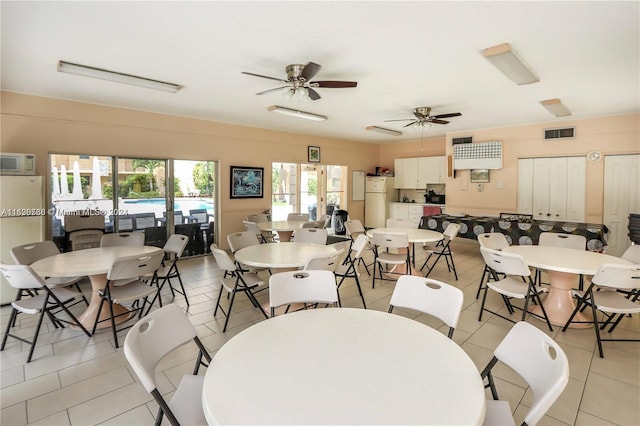 dining room featuring light tile patterned flooring, french doors, and ceiling fan