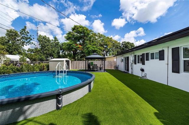 view of pool with a gazebo, a shed, and a yard