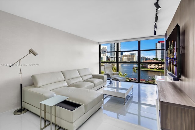 living room with track lighting, floor to ceiling windows, and a wealth of natural light