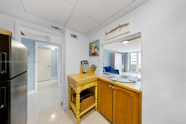 kitchen with stainless steel refrigerator with ice dispenser and light tile patterned floors