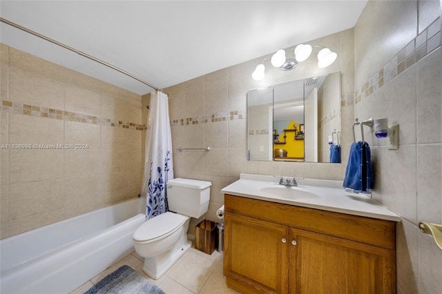 full bathroom with shower / bath combo, tile patterned floors, vanity, tile walls, and toilet