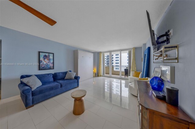 living room with expansive windows and light tile patterned floors