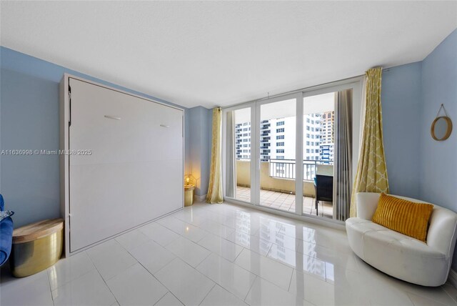 interior space with floor to ceiling windows and light tile patterned floors