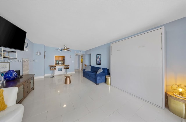 tiled living room with ceiling fan