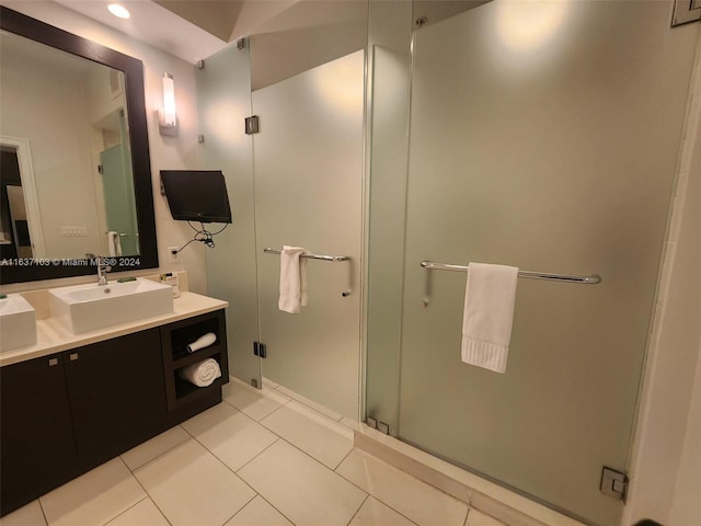 bathroom with tile patterned flooring, a shower with shower door, and vanity