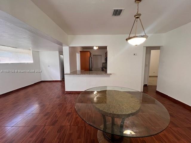 unfurnished dining area with dark hardwood / wood-style flooring