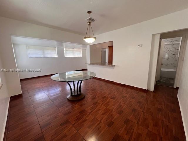 unfurnished dining area featuring baseboards