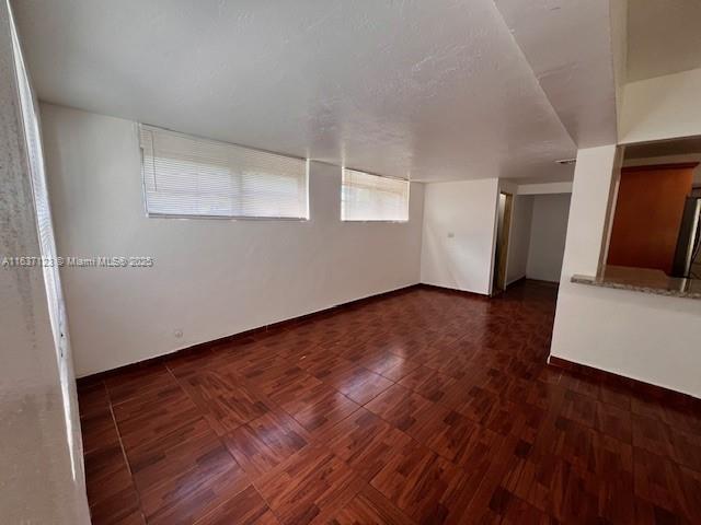 unfurnished room with wood finished floors