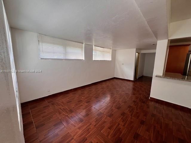 unfurnished room featuring dark hardwood / wood-style flooring