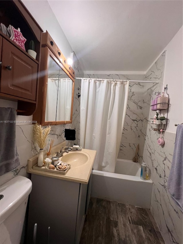 full bathroom featuring shower / bath combo with shower curtain, toilet, tile walls, hardwood / wood-style floors, and vanity