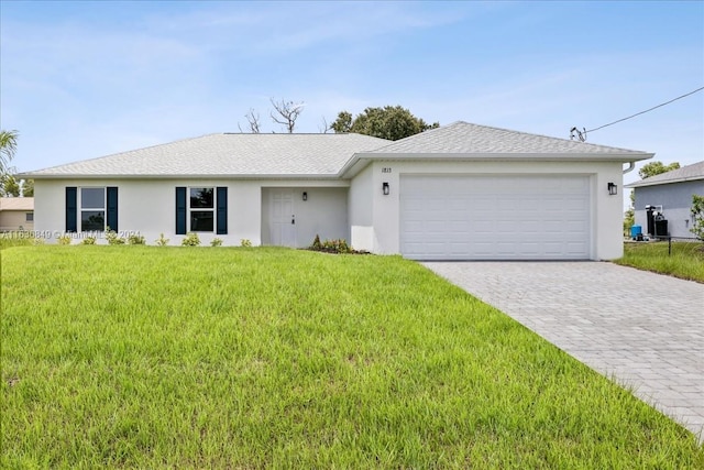 single story home with a garage and a front lawn