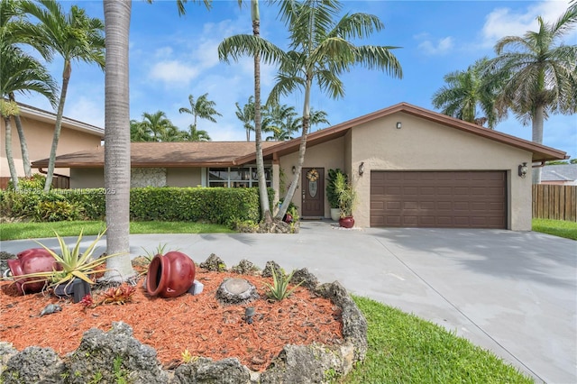 12861 SW 149th St, Miami, FL 33186 - view of front of house featuring stucco siding, an attached garage, and driveway