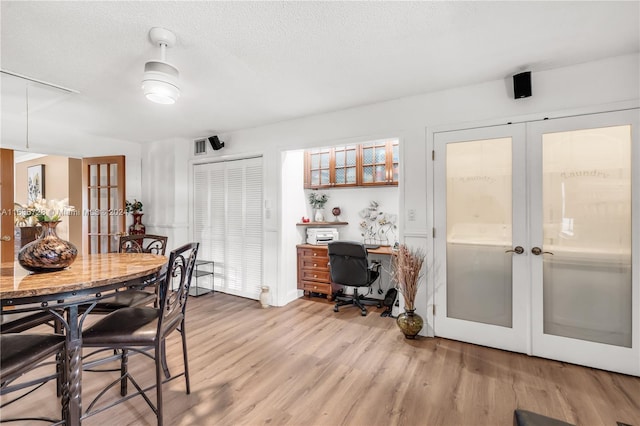 dining space featuring french doors and light hardwood / wood-style flooring