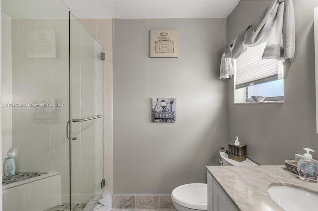 bathroom featuring tile patterned floors, a shower with shower door, vanity, and toilet