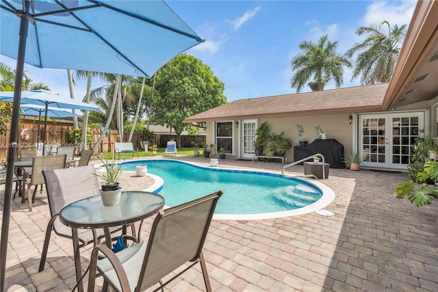 view of swimming pool with a patio area and french doors