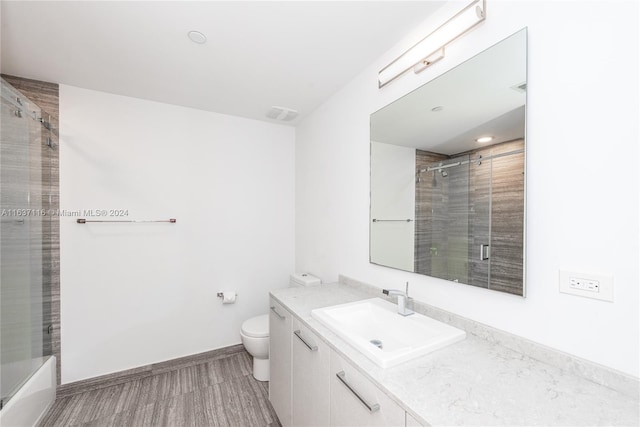 bathroom featuring hardwood / wood-style floors, vanity, and toilet