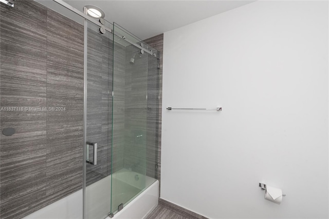 bathroom featuring shower / bath combination with glass door