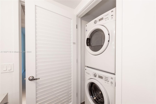 laundry room with stacked washing maching and dryer