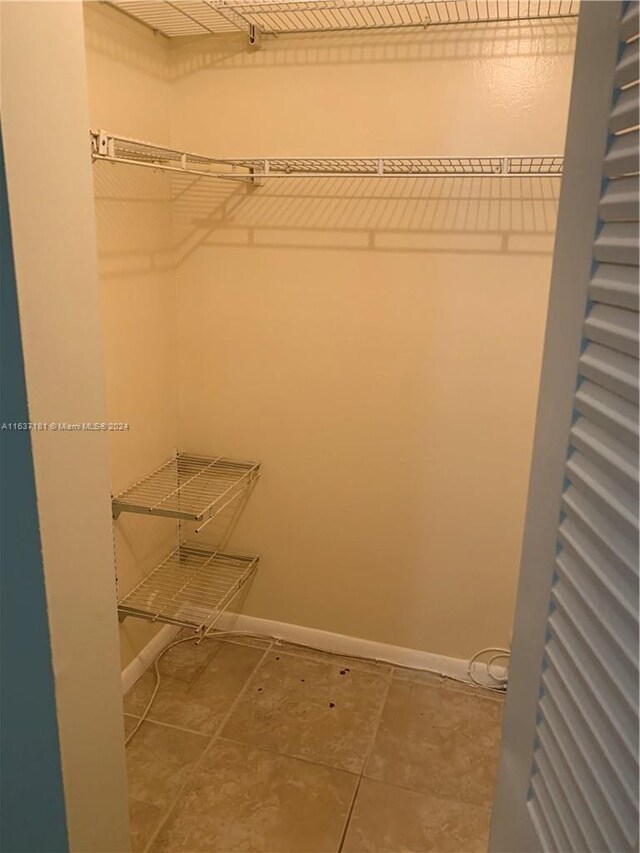 walk in closet featuring tile patterned flooring