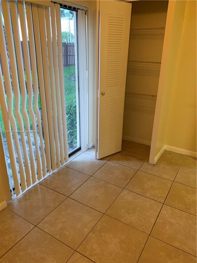 unfurnished bedroom featuring a closet and light tile patterned floors