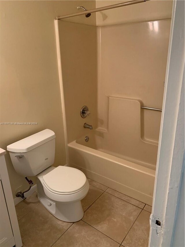 full bathroom featuring vanity, toilet,  shower combination, and tile patterned floors