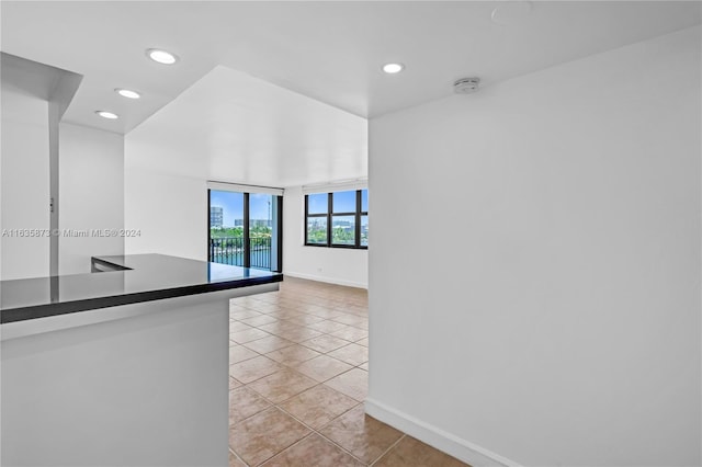 spare room featuring light tile patterned flooring