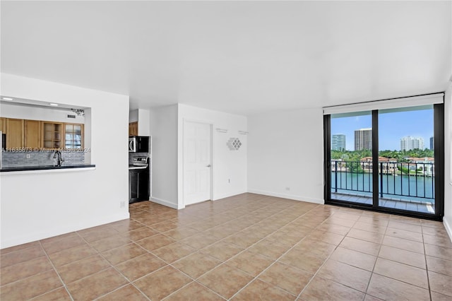 unfurnished living room featuring light tile patterned floors