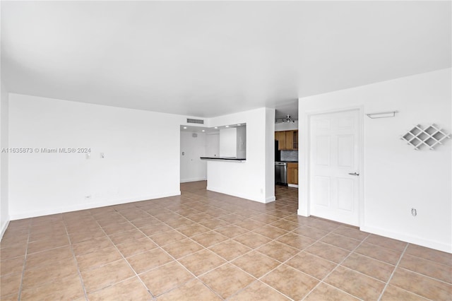 unfurnished living room with light tile patterned flooring