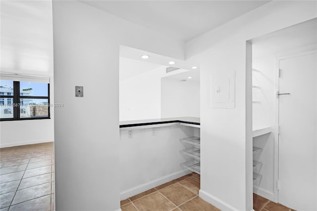 spacious closet featuring light tile patterned flooring and electric panel