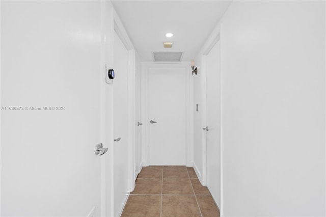 hallway with tile patterned flooring