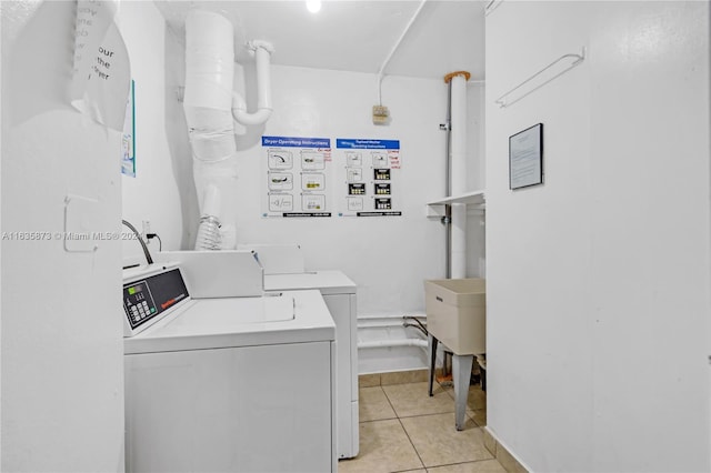 laundry room featuring light tile patterned flooring and separate washer and dryer