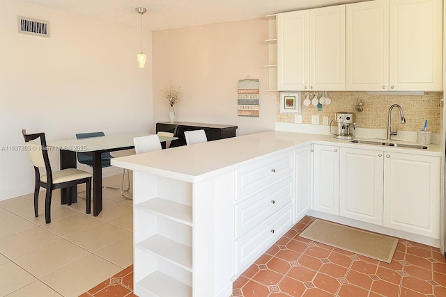 13781 SW 66th St Unit 221B, Miami, FL 33183 - kitchen with open shelves, a peninsula, tasteful backsplash, and light countertops