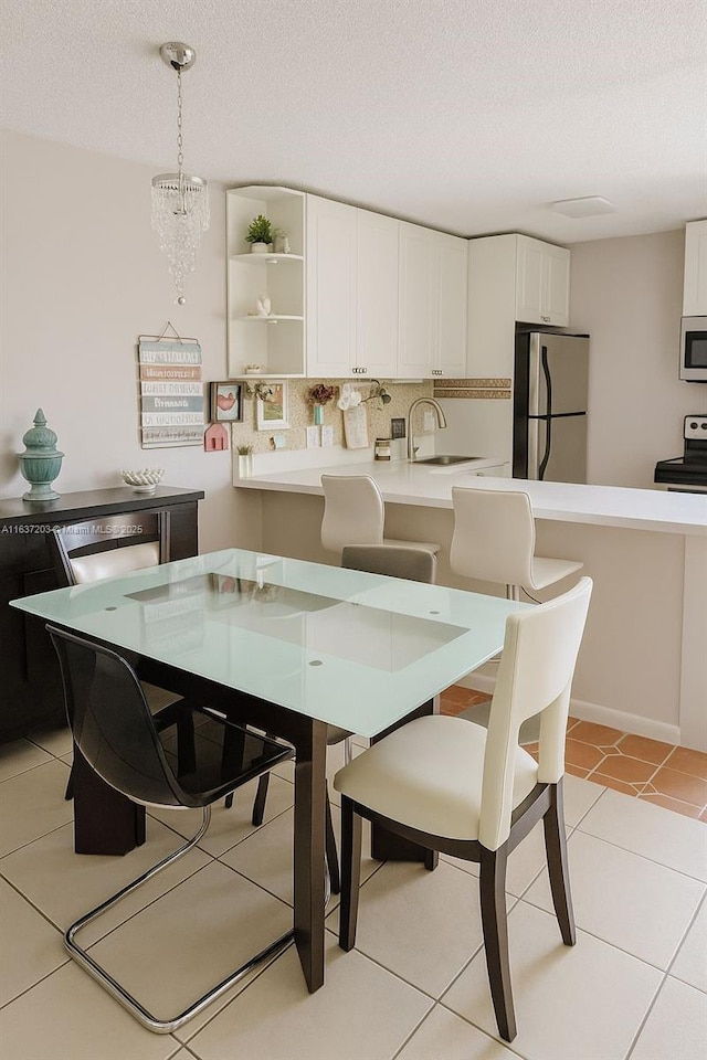 13781 SW 66th St Unit 221B, Miami, FL 33183 - dining room featuring a textured ceiling and light tile patterned flooring