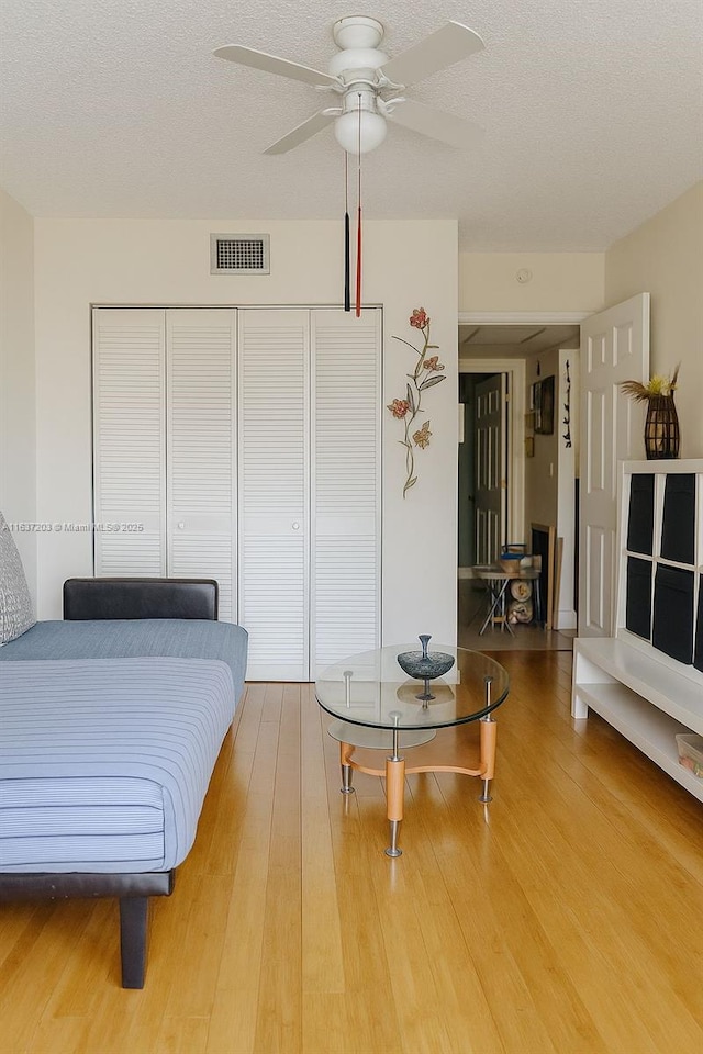 13781 SW 66th St Unit 221B, Miami, FL 33183 - bedroom featuring wood finished floors, a closet, a textured ceiling, and ceiling fan
