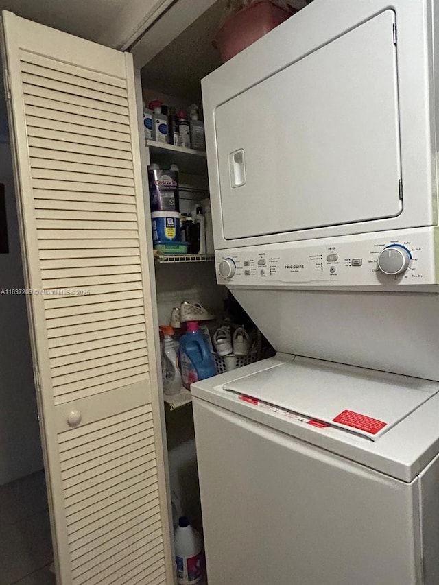 laundry room with stacked washing maching and dryer