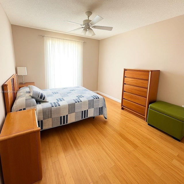 13781 SW 66th St Unit 221B, Miami, FL 33183 - bedroom featuring light wood-type flooring, a textured ceiling, and a ceiling fan
