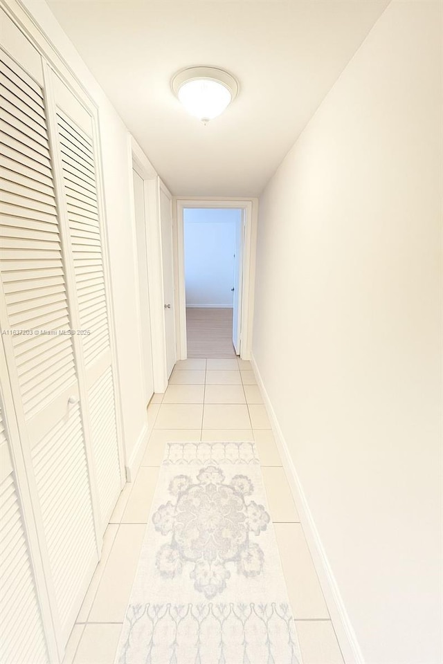 13781 SW 66th St Unit 221B, Miami, FL 33183 - hallway with light tile patterned floors and baseboards