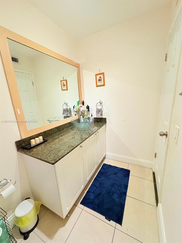 bathroom with tile patterned flooring, baseboards, visible vents, and vanity