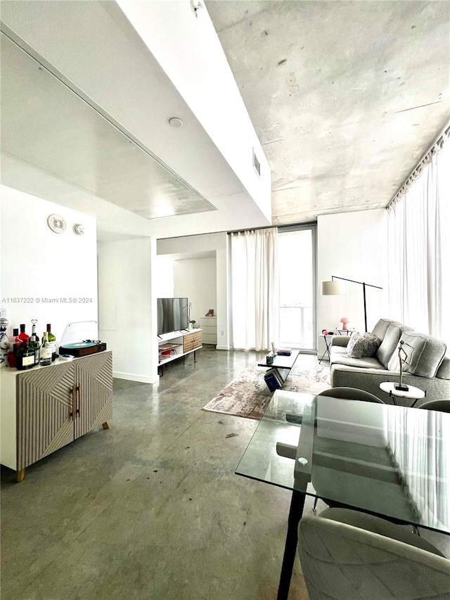 living room featuring concrete flooring