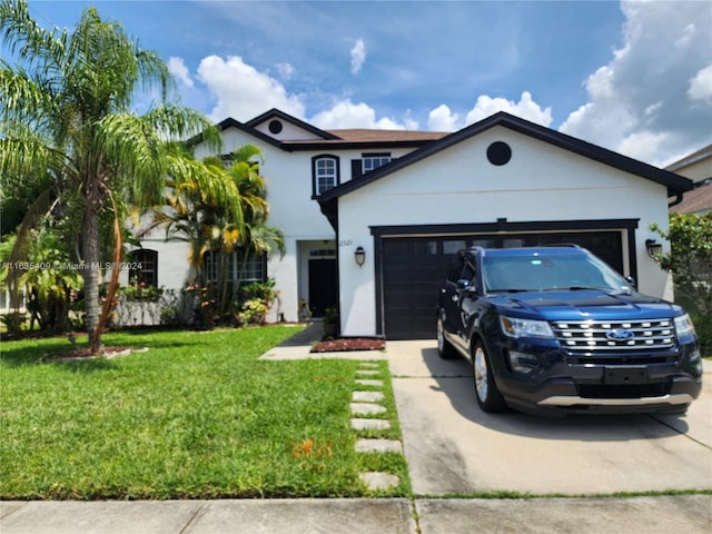 view of front facade with a garage and a front lawn