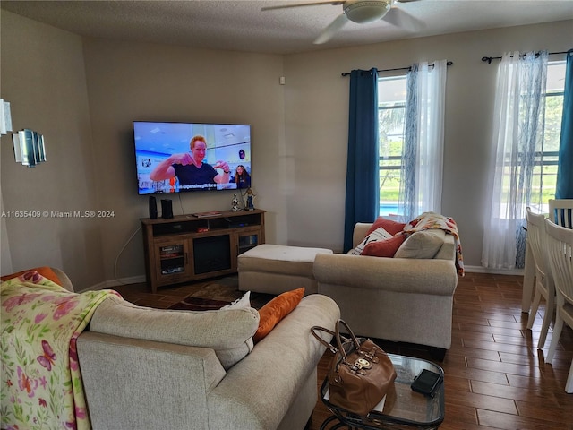 living room with a textured ceiling, ceiling fan, and hardwood / wood-style floors